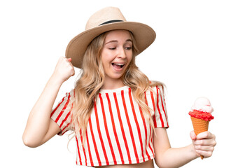 Young English woman with a cornet ice cream over isolated background celebrating a victory