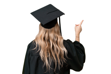 Young university English graduate woman over isolated background pointing back with the index finger