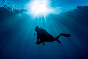 scuba diver at safety stop under the sun