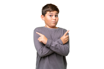 Little caucasian kid over isolated chroma key background pointing to the laterals having doubts