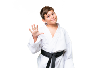 Little caucasian kid doing karate over isolated chroma key background counting five with fingers