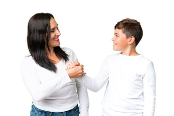 Little caucasian kid over isolated chroma key background handshaking after good deal