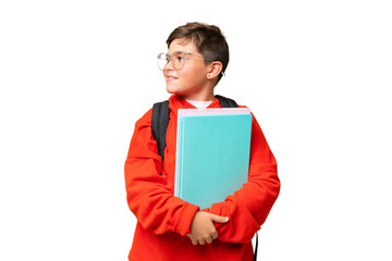 Little caucasian student kid over isolated chroma key background looking to the side and smiling
