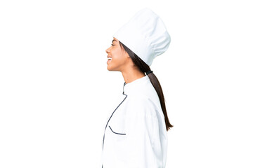 Young African American chef over isolated chroma key background laughing in lateral position