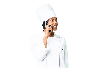 Young African American chef over isolated chroma key background keeping a conversation with the mobile phone