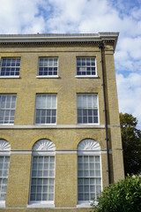 Fototapeta premium Typical Georgian building façade. light brick exterior of elegant building 