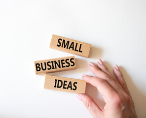 Small Business Ideas symbol. Wooden blocks with words Small Business Ideas. Businessman hand. Beautiful white background. Business and Small Business Ideas concept. Copy space.