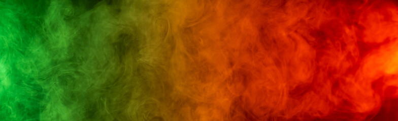 Red yellow green smoke on a black background.