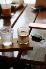 dirty coffee iced latte freeze milk pour espresso shot in a cup of coffee on scale measurement wooden bar table cafe in thailand asia by barista workout