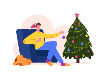Young man in chair decorating Christmas tree with bauble