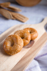 Bagels on a wooden board, on a gray background. Place for text