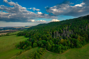 Flying over some golden fields and green forests. Germany.