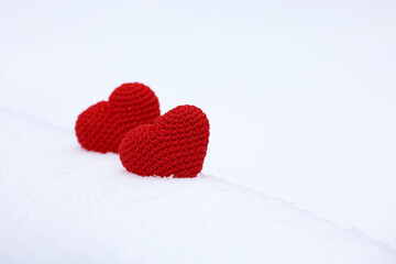 Fototapeta premium Two love hearts in snow, Valentine's card. Background for romantic event, Christmas celebration or winter weather