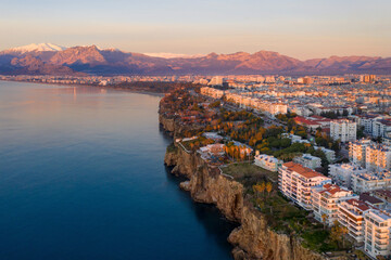 Aerial view of Antalya and covered with snow mountains at sunrise, Turkey.
