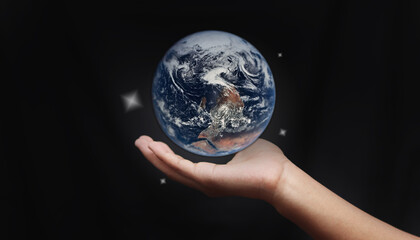 Together we can save the world and offer the better world for our children and Earth day concept, Butterfly and love heart shaped earth on hands, Elements of this image furnished by NASA