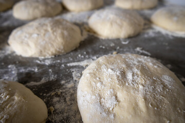 Dough for pizza in the process of leavening. Selective focus.