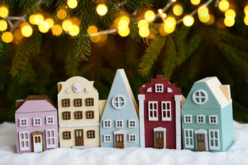 Fairy tale Christmas town, multicolor wooden houses, christmas tree and garlands. New year decoration. Holiday card. Christmas background
