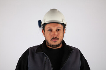 Portrait of a man with hard cap on white isolated background.