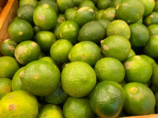 close up view of fresh and healthy lime on the market rack. selective focus of citrus background