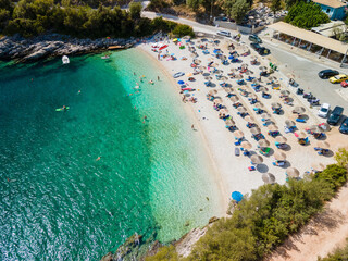 Lefkada island beach overhead view people on sun loungers