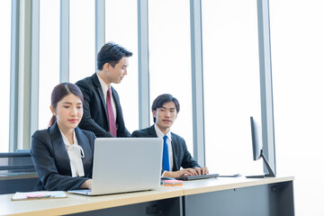 A group of young Asian businessmen Talking and planning work happily and have fun. at the company's office