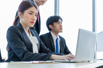Fototapeta premium A group of young Asian businessmen Talking and planning work happily and have fun. at the company's office