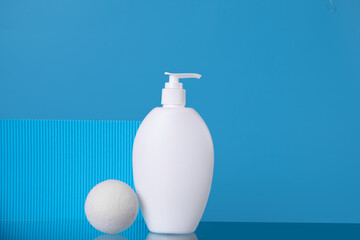 Blank mock up bottle beauty cosmetic skin care organic product for bathing routine with bath salt on blue background. Place your design.