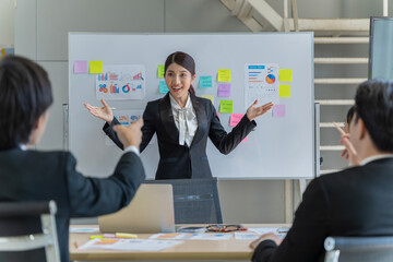 A group of young Asian businessmen Talking and planning work happily and have fun. at the company's office
