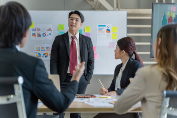 A group of young Asian businessmen Talking and planning work happily and have fun. at the company's office