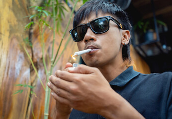 Young man smoking cigarettes with medical marijuana