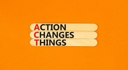ACT action changes things symbol. Concept words ACT action changes things on wooden sticks on a beautiful orange table orange background. Business and ACT action changes things concept. Copy space.