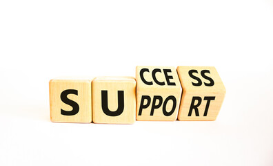 Success and support symbol. Concept word Success and Support on wooden cubes. Beautiful white table white background. Business success and support concept. Copy space.