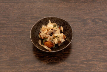 A nice bowl full of Takoyaki, which are delicious flour spheres that are traditionally filled with a small piece of octopus, but in Yaki-Yaki we also fill them with prawns