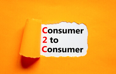 C2C consumer to consumer symbol. Concept words C2C consumer to consumer on white paper on a beautiful orange background. Business and C2C consumer to consumer concept. Copy space.