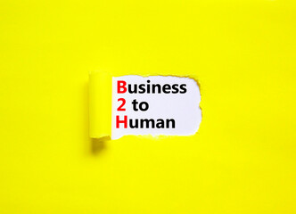 B2H business to human symbol. Concept words B2H business to human on white white paper on a beautiful yellow background. Business and B2H business to human concept. Copy space.