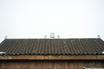 A rumah adat Jawa Tengah, also known as a rumah Joglo, is a typical dwelling in Central Java,...