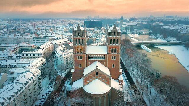 Munich winter skyline aerial view of St. Maximilian is a Roman Catholic parish church of the Isar suburb in Munich, southern Germany. Munich winter snow skyline aerial view isar river church downtown.