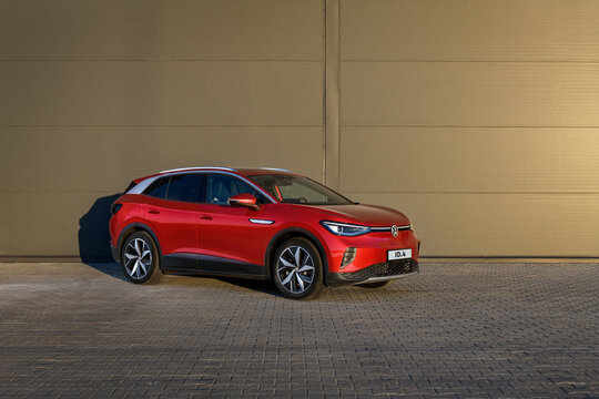 Kyiv, Ukraine - October 7, 2022: New electric car Volkswagen ID.4 near gray storehouse