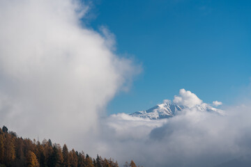 The snowy mountains in the clouds panorama