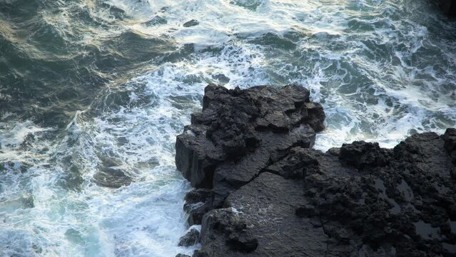 Icelandic Black Coast at Sunset, Volcanic Cliffside with Blue North Atlantic Ocean Water, Shot in 8K Resolution 4320p