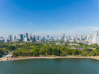 Fototapeta premium Aerial view city green forest public park with modern office building Benjakitti Park
