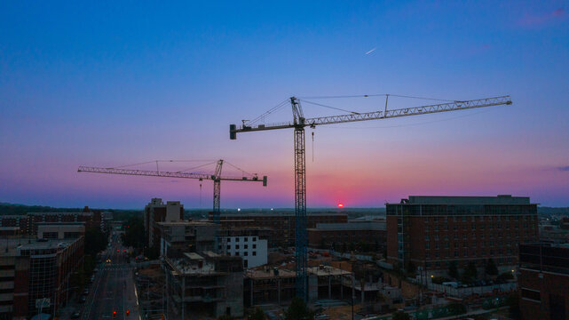 crane silhouette construction area on college campus 