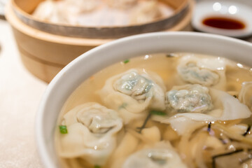 Meat dumpling in soup bowl