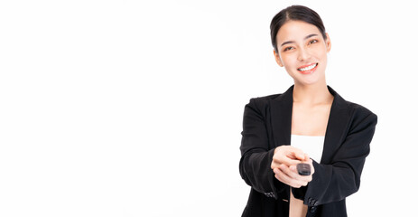Happy young smiling satisfied successful Asian business woman in suit hold in hands giving car key...