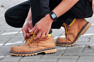 Close up of a man tying his work boots