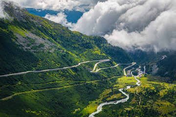 Alpine road with serpentines over the clouds, Furka pass, Switzerland