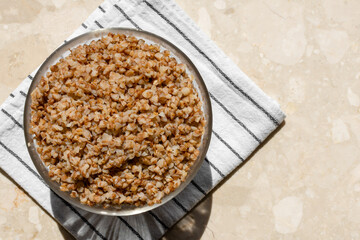 boiled buckwheat porridge in a transparent glass bowl top view