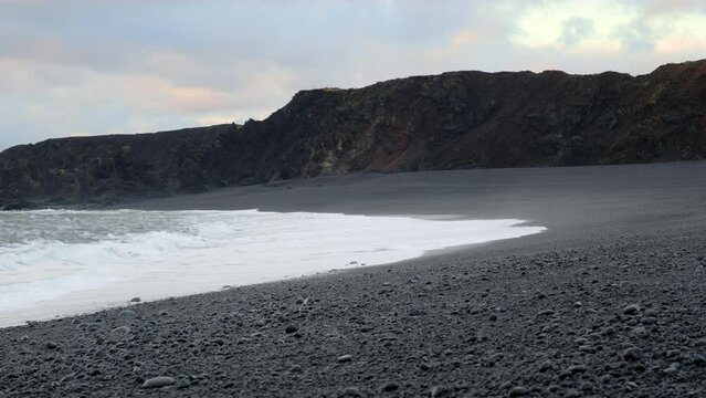 Icelandic Black Sand Beach Coast at Sunset, Volcanic Cliffside with Blue North Atlantic Ocean Water, Shot in 8K Resolution 4320p