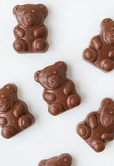 Chocolate teddy bear on a white background. Charming chocolate and delicious gift.