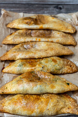Assortment of homemade stuffed dumplings, on wooden background